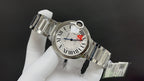 Cartier watch 3/4 view with silver dial, red A detail, and steel bracelet links