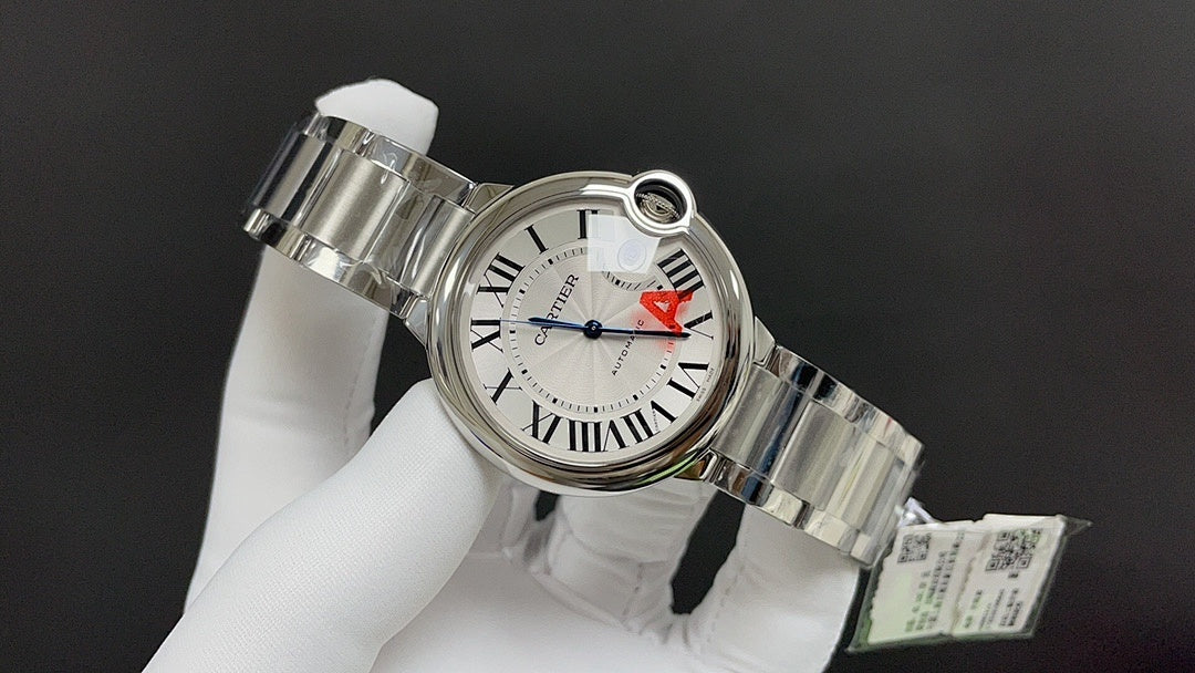 Cartier watch 3/4 view with silver dial, red A detail, and steel bracelet links