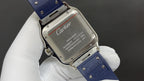 Cartier watch case back with engraved metal plate and blue leather strap