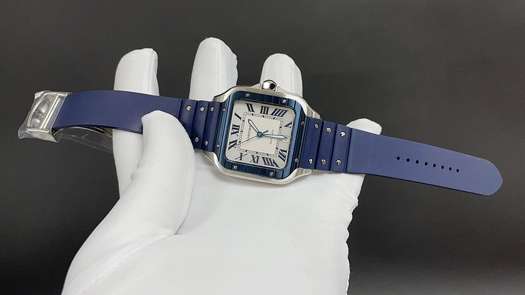 Cartier square watch with blue leather strap and silver case, held flat