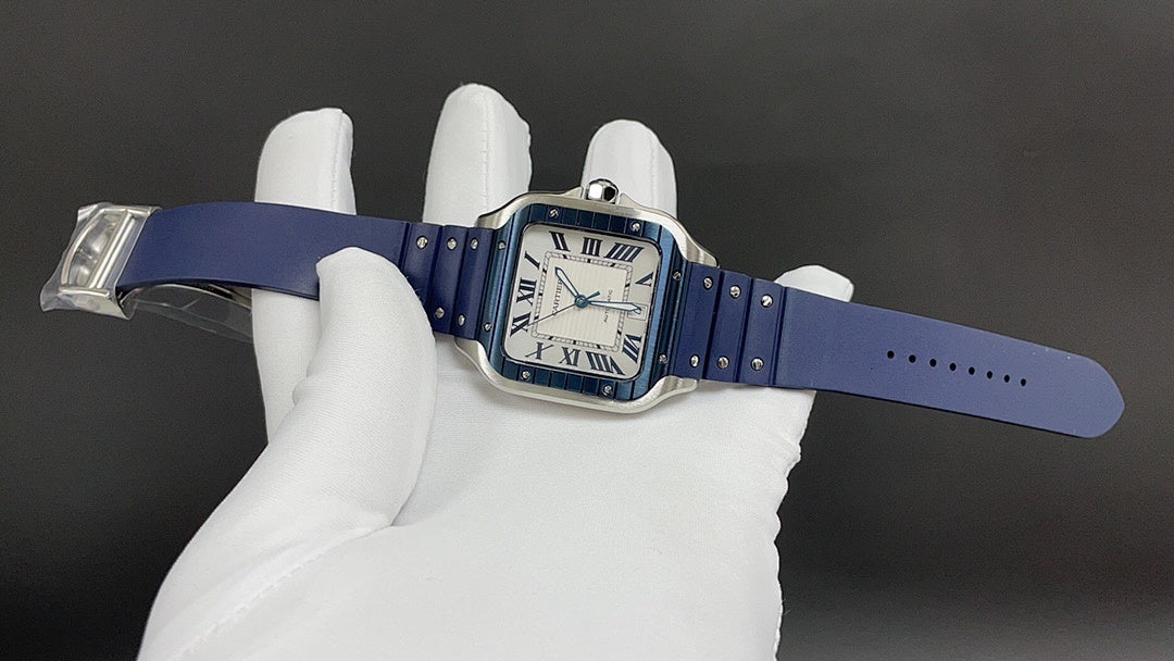 Cartier square watch with blue leather strap and silver case, held flat