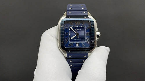 Cartier watch with blue dial, Roman numerals, and blue leather strap on white glove