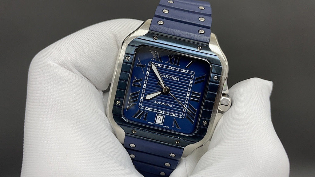 Cartier watch front with blue dial and blue leather strap held in white glove