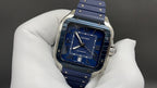 Cartier watch front with blue dial and blue leather strap held in white glove