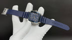 Cartier watch on hand with blue leather strap, blue dial, and stainless steel case
