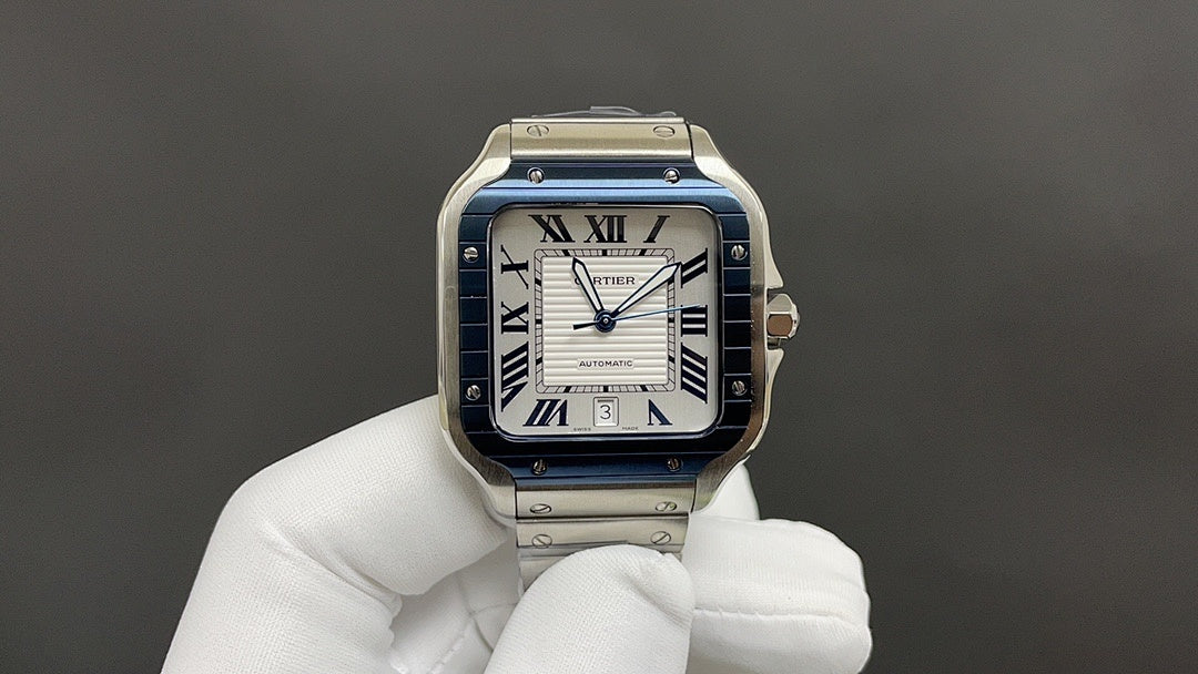 Cartier Santos-style watch with blue bezel, Roman numeral dial, stainless steel bracelet