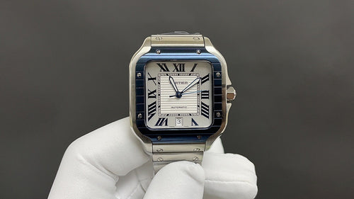 Cartier Santos-style watch with blue bezel, Roman numeral dial, stainless steel bracelet