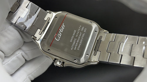 Cartier watch case back with stainless steel bracelet and clasp, engraved text panel