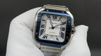 Cartier watch with blue Roman numeral dial, square face, stainless steel strap