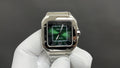 Cartier watch with green dial, black bezel, Roman numerals, steel bracelet