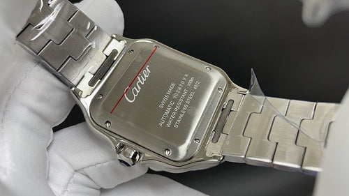 Cartier watch case on steel bracelet, engraved dial plate visible