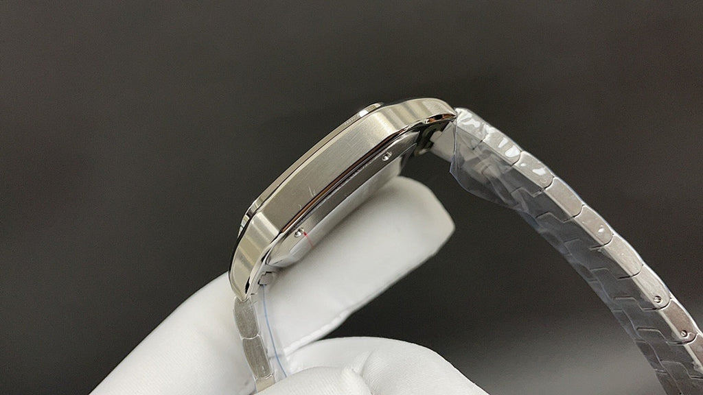 Cartier watch with steel bracelet, angled side view of polished case