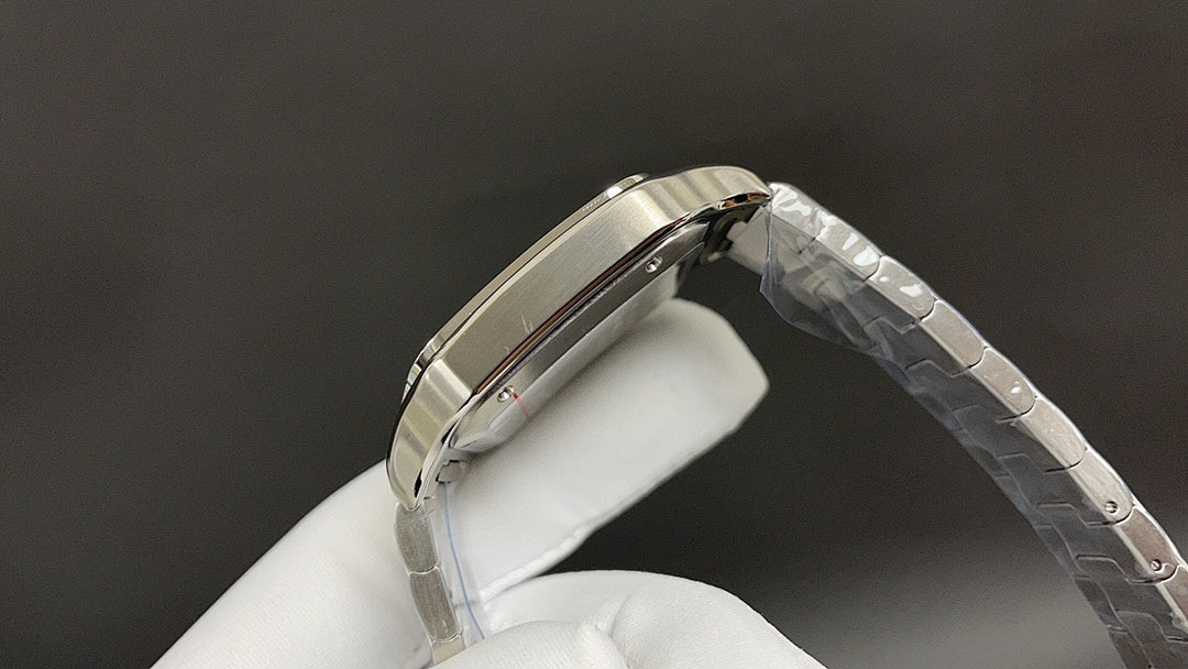 Cartier watch with steel bracelet, angled side view of polished case