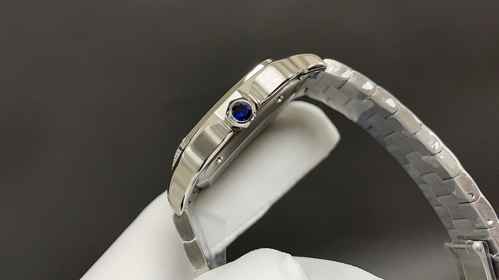 Cartier watch with steel bracelet, side view of case and blue gemstone crown