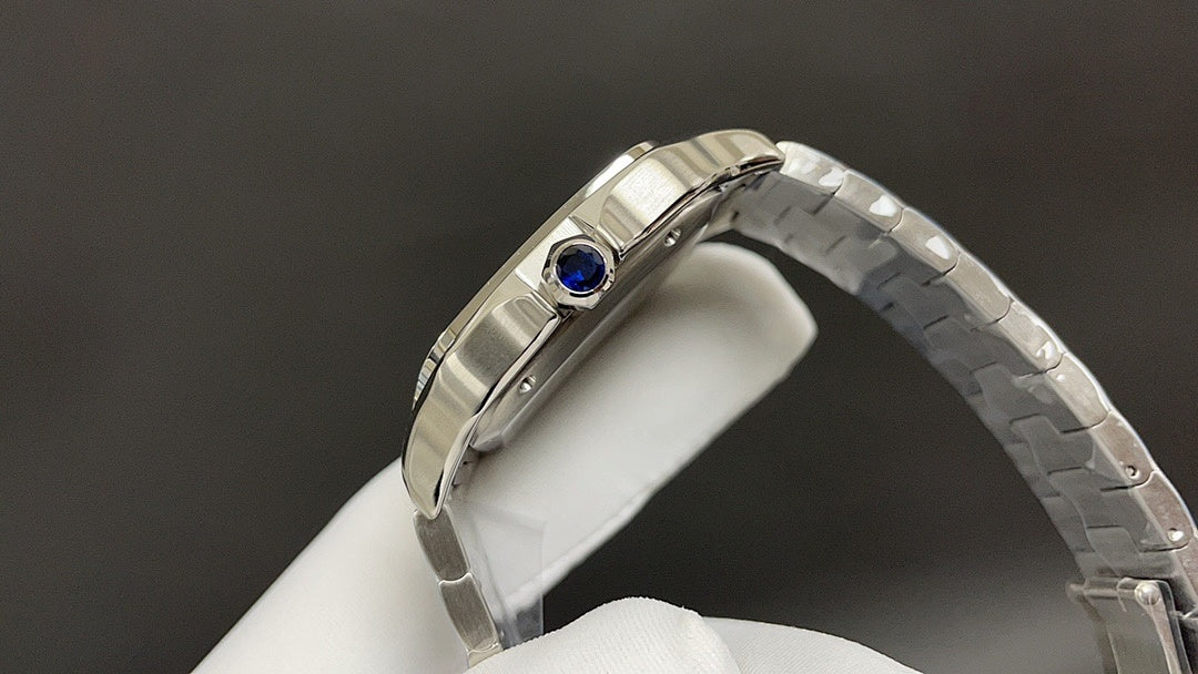 Cartier watch with steel bracelet, side view of case and blue gemstone crown