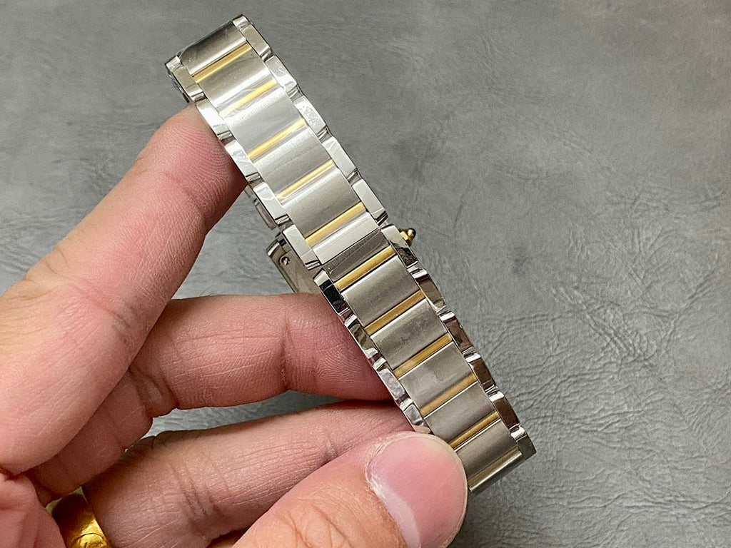 Two-tone metal wristwatch bracelet in side view with rectangular links