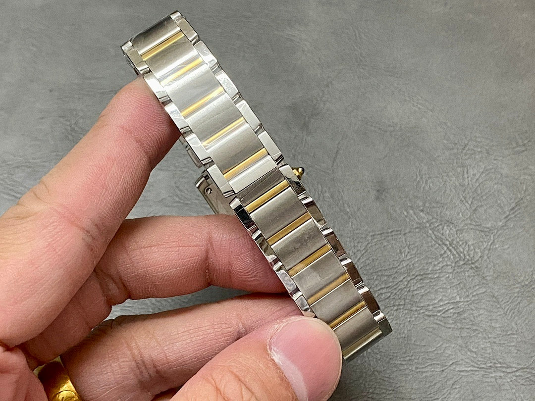 Two-tone metal wristwatch bracelet in side view with rectangular links