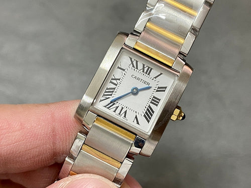 Wristwatch with two-tone metal bracelet, rectangular white dial, Roman numerals, crown