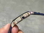 Cartier watch crown and bezel on stainless case, blue strap edge