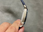 Cartier watch side profile with stainless case and blue leather strap