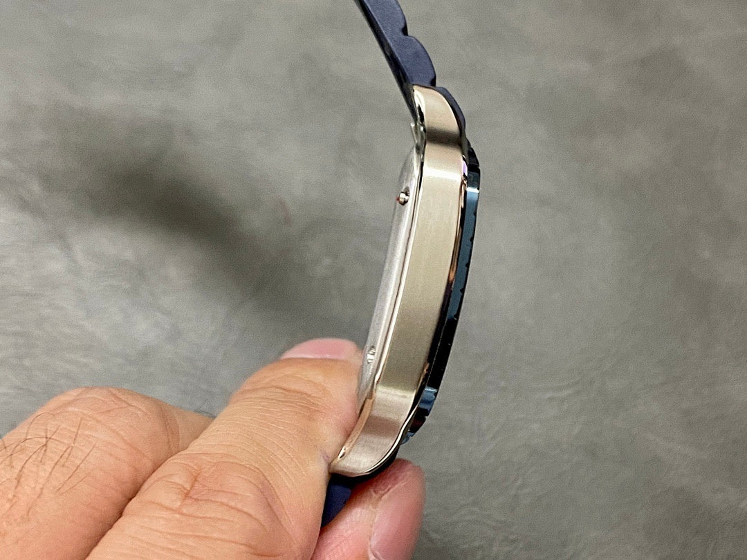 Cartier watch side profile with stainless case and blue leather strap