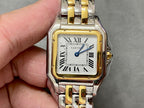 Cartier watch with gold bezel, silver-and-gold bracelet, roman numeral dial and blue hands