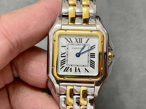 Cartier watch with gold bezel, silver-and-gold bracelet, roman numeral dial and blue hands