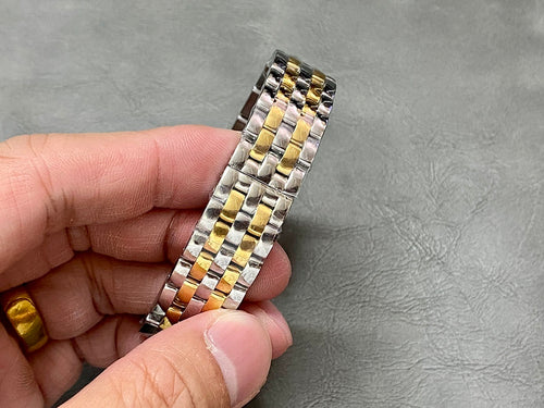 Cartier watch bracelet with alternating silver and gold metal links