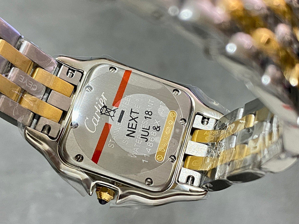 Cartier watch case back with engraved text and metal bracelet clasp