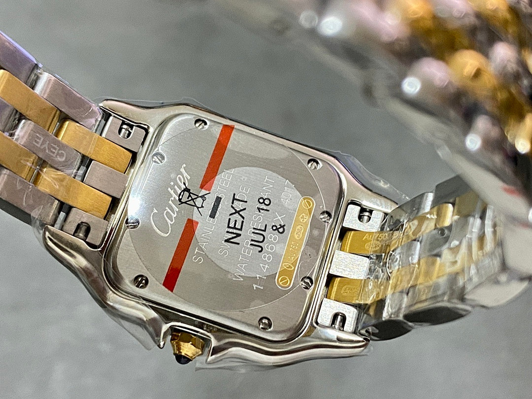 Cartier watch case back with engraved text and metal bracelet clasp
