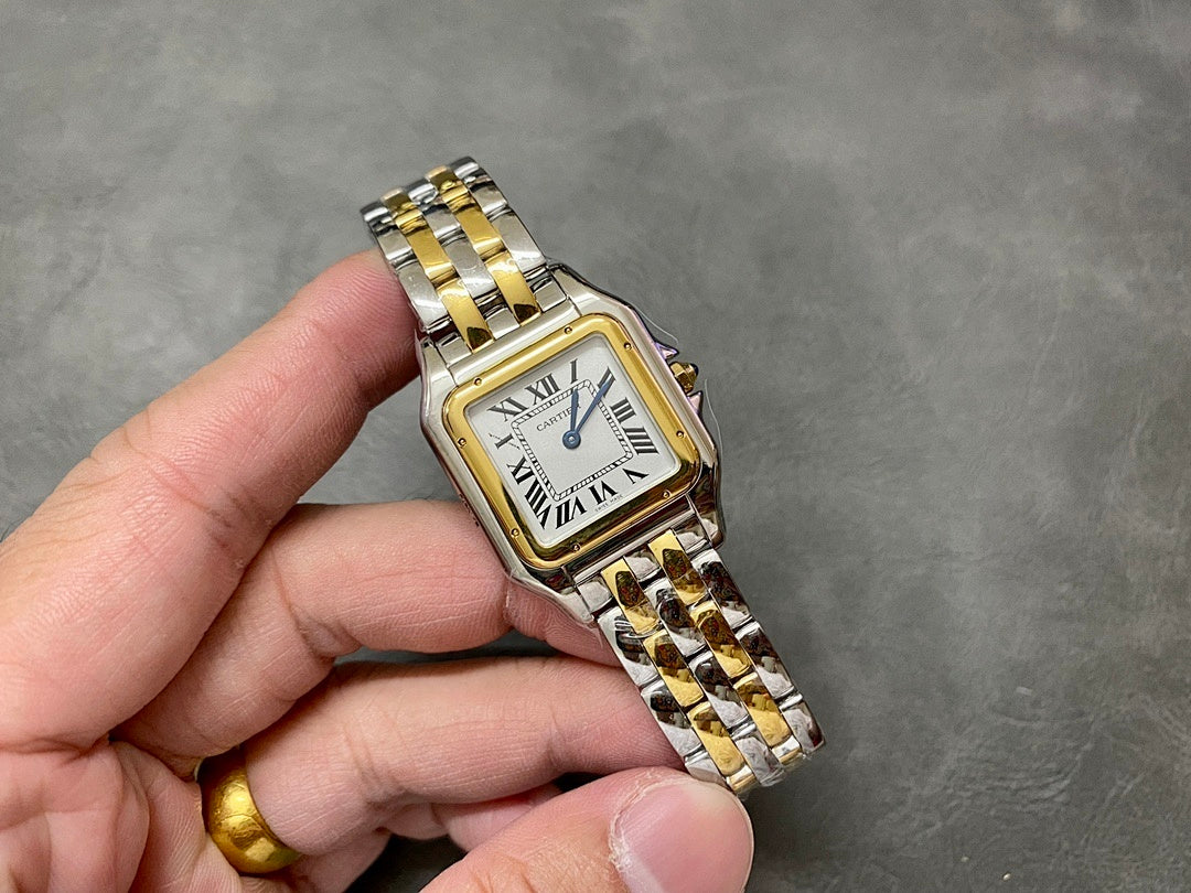 Cartier watch front view with two-tone bracelet, roman numerals, and blue hands