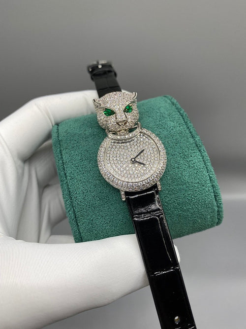 Cartier watch with round diamond dial, green eyes, and black leather strap