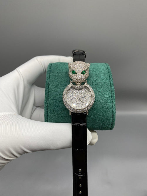 Cartier watch with black leather strap and jeweled round dial with green cat motifs