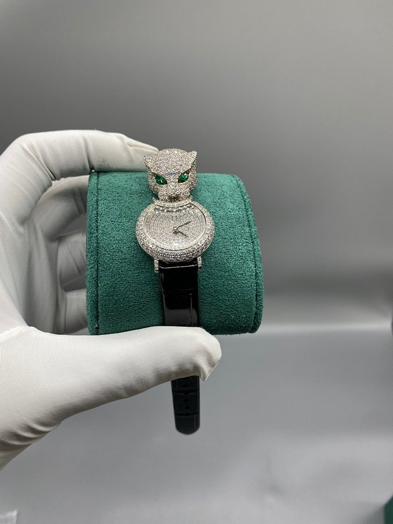 Cartier watch with green cat head ornament, jeweled round dial, black strap