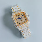 Diamond-set square wristwatch with gold dial, blue hands, silver bracelet with studs