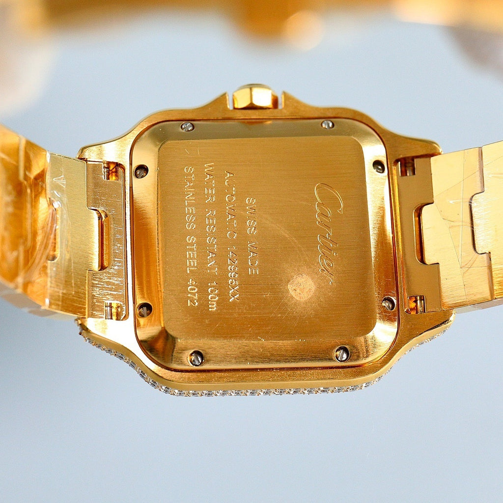 Cartier gold wristwatch case back with engraved markings and metal clasp links