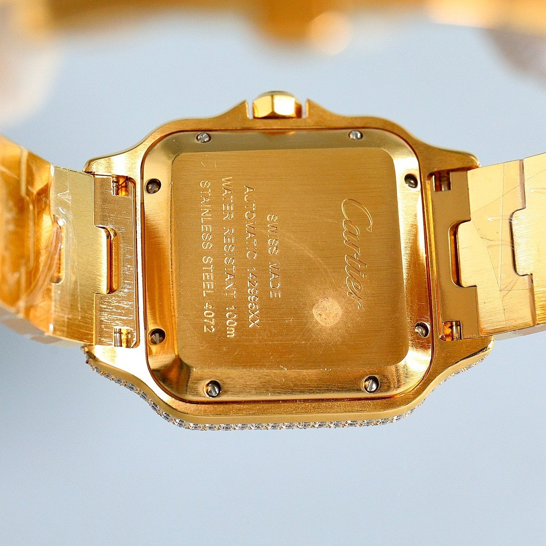 Cartier gold wristwatch case back with engraved markings and metal clasp links