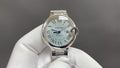 Cartier automatic wristwatch with silver dial, Roman numerals, and steel bracelet