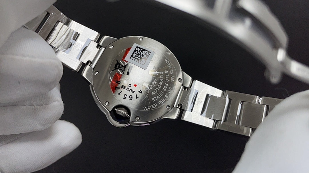 Cartier automatic wristwatch caseback on steel bracelet with engraved markings