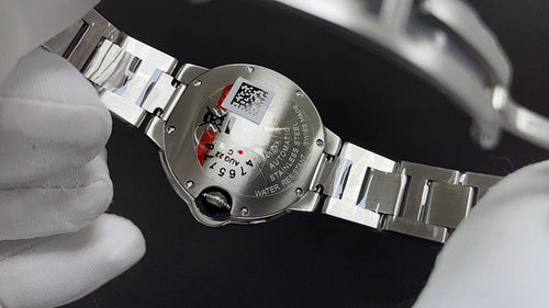 Cartier automatic wristwatch caseback on steel bracelet with engraved markings