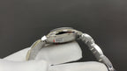 Cartier automatic wristwatch side view with crown and steel bracelet links