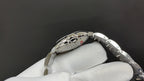 Cartier automatic wristwatch angled view showing engraved case and bracelet