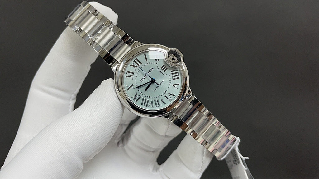 Cartier automatic wristwatch tilted view with crown, steel bracelet, and bezel