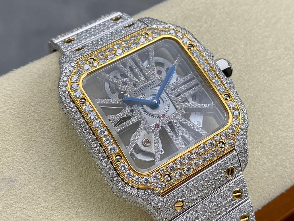 Square diamond watch with silver bracelet, gold-trimmed bezel, and blue dial hands