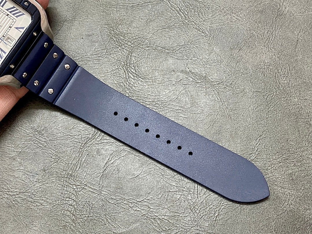 Blue leather watch strap with rows of small metal rivets and punched sizing holes