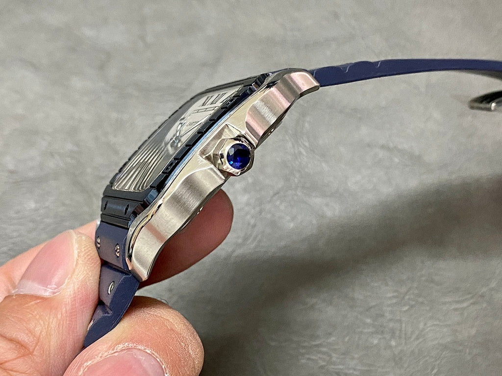 Cartier watch side view with crown and sapphire-blue gemstone set in the bezel