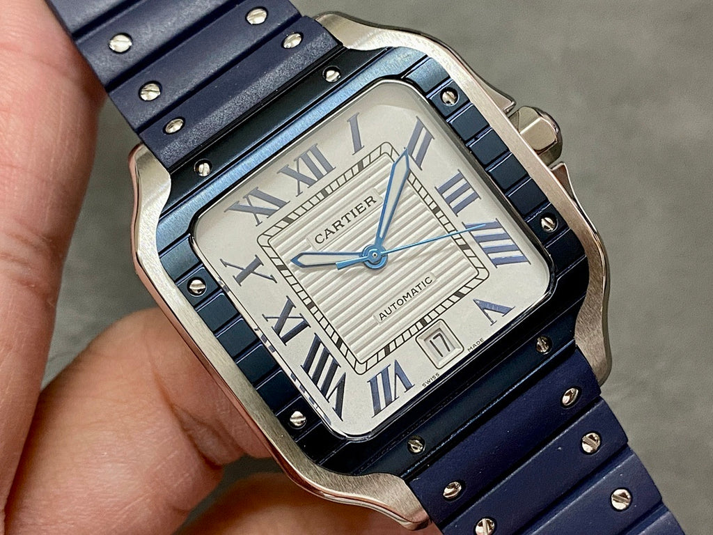Cartier watch with silver case, white dial, blue hands, Roman numerals, blue strap