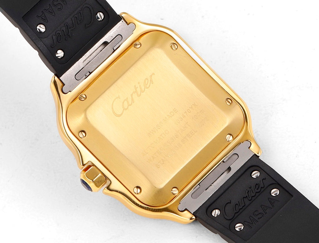 Cartier watch case back with gold-tone square backplate and black rubber strap.
