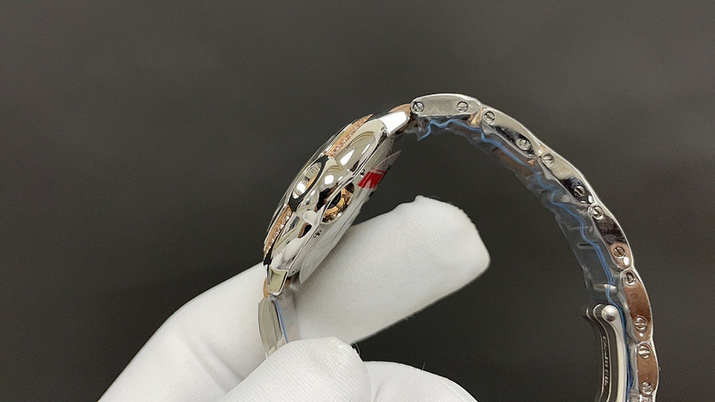 Cartier watch with silver-tone bracelet links and curved bezel setting