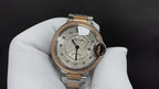 Cartier watch with white dial, diamond-like bezel detail, and metal band with gold accents